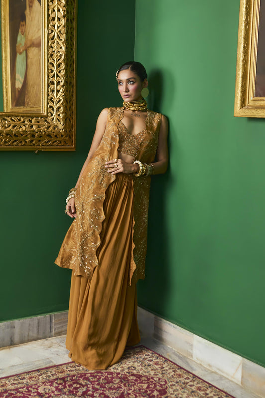 "Wisp" Cape with Embroidered blouse and pleated pant.