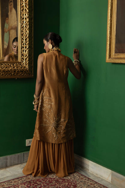 "Wisp" Cape with Embroidered blouse and pleated pant.